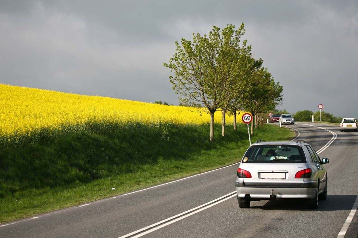 Landevej med biler i et sving